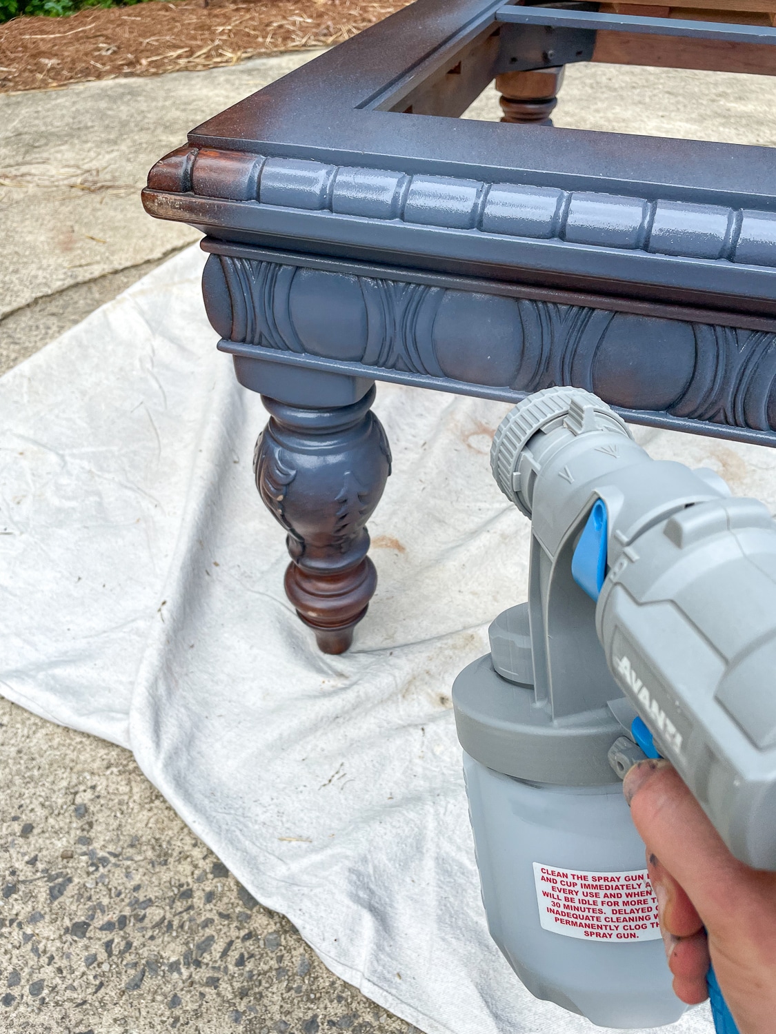 paint sprayer painting coffee table blue