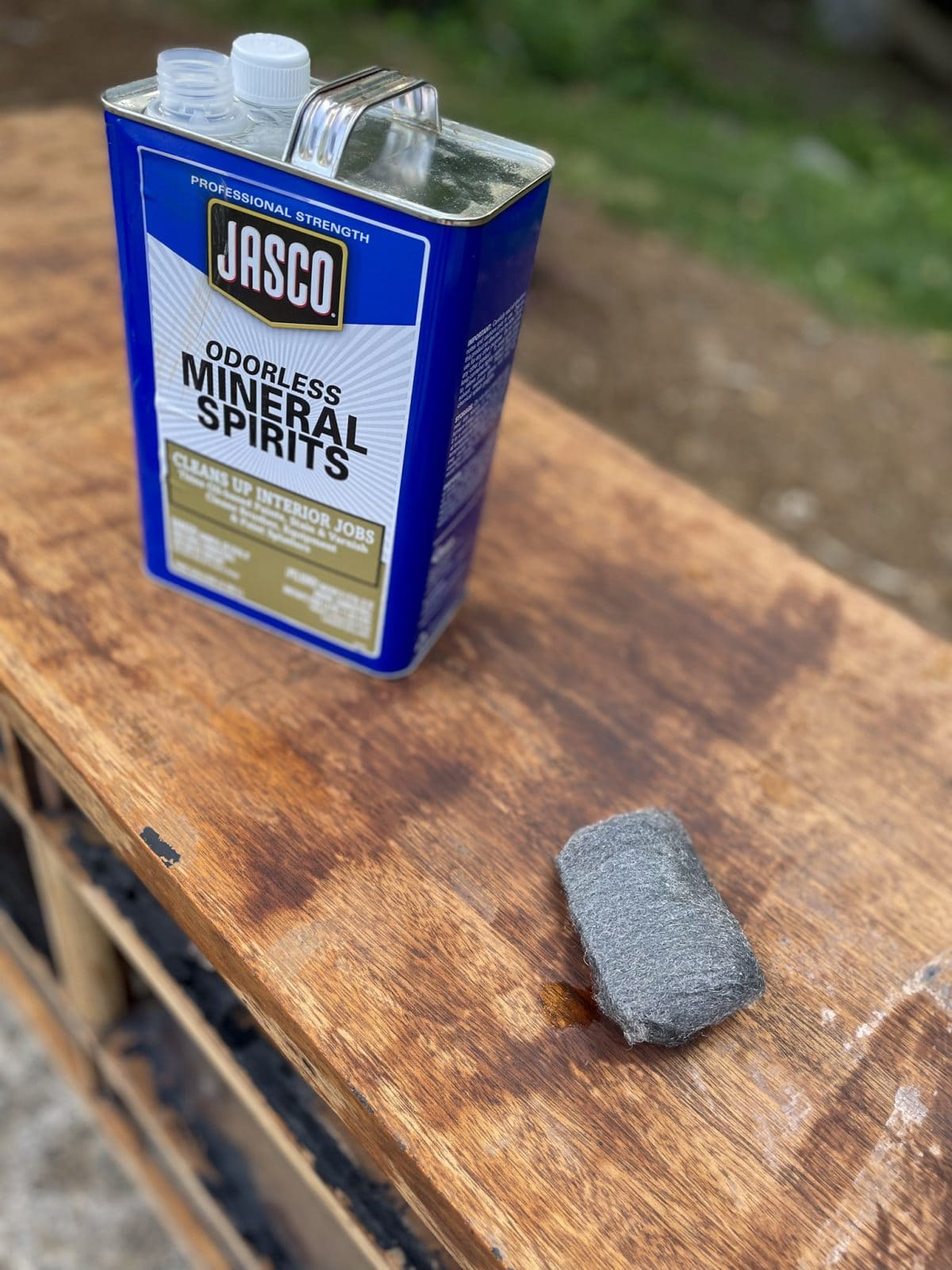 can of mineral spirits and steel wool sitting on dresser