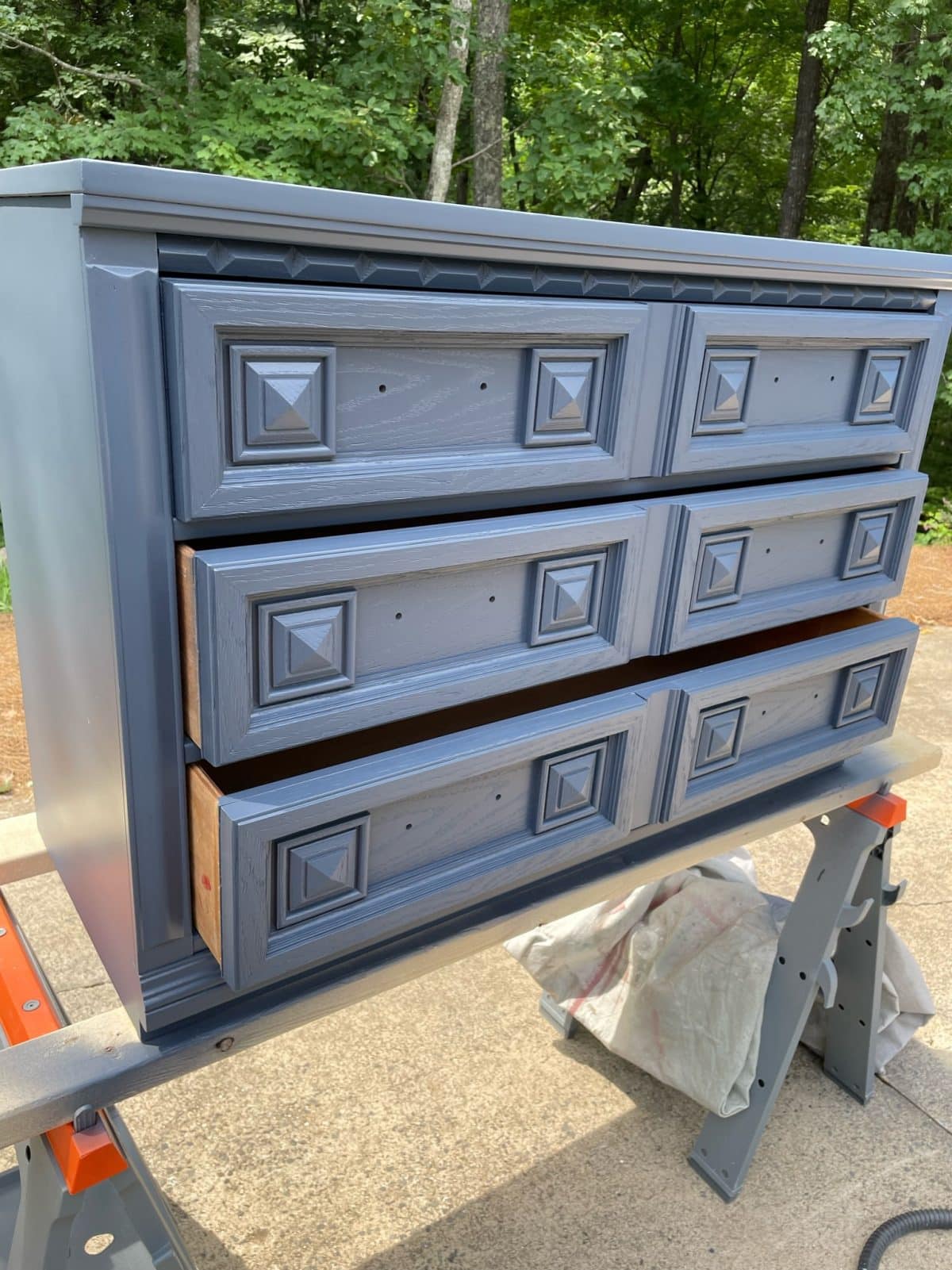 painted dresser sitting on two sawhorses