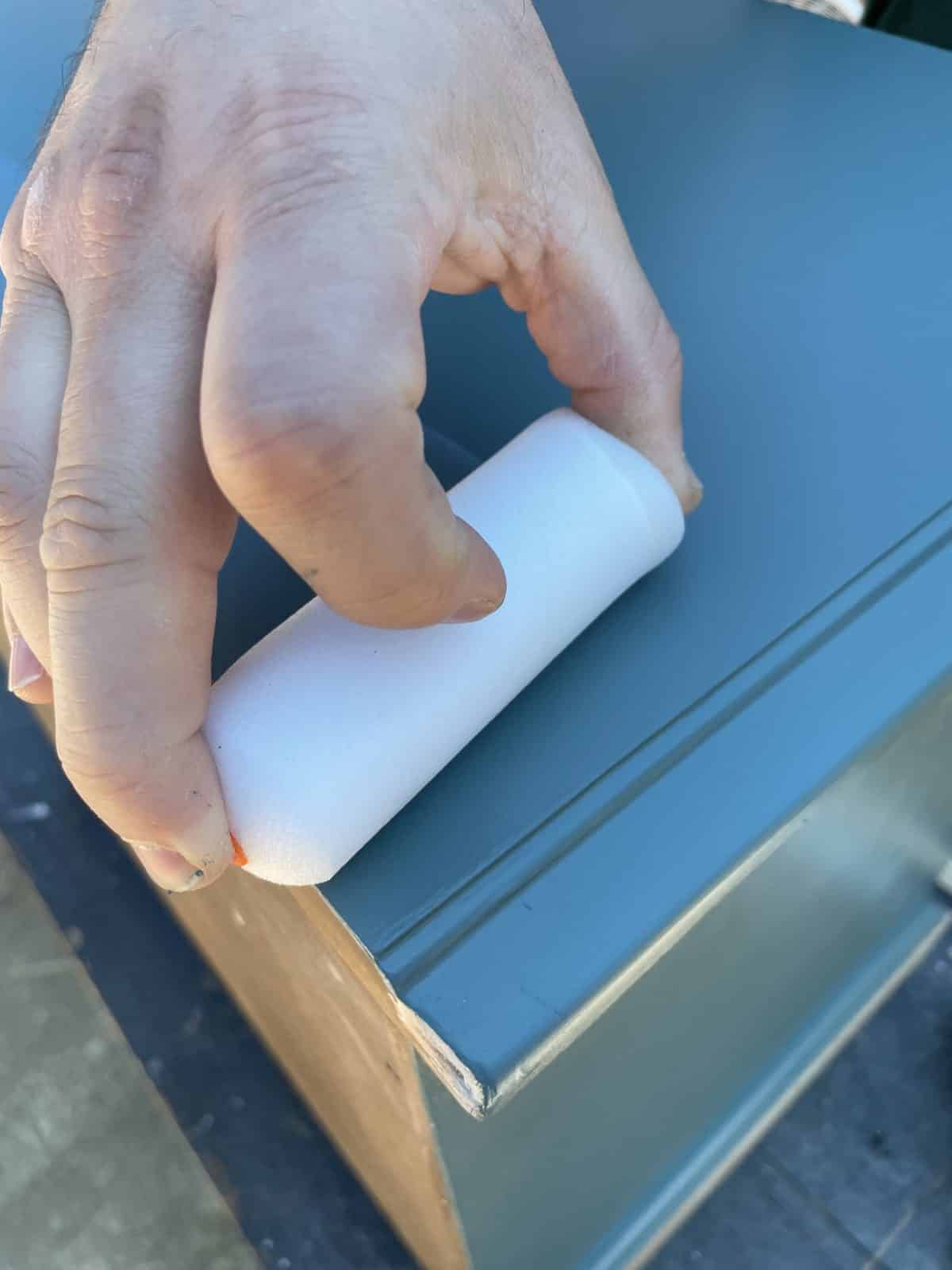 hand dragging a 4" foam roller dipped in poly across the top of the nightstand