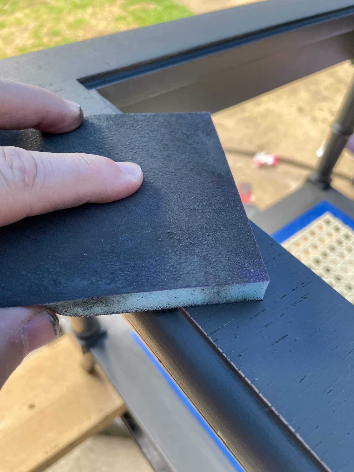 sanding sponge sanding base coat of black paint
